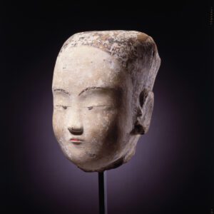 A painted pottery head of a young woman