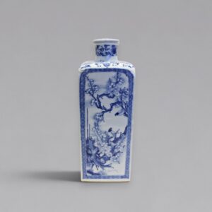 A blue and white square-form flask and cover