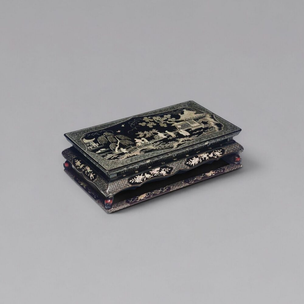 A finely carved black and red lacquer ‘Kang’ table with mother-of-pearl inlay