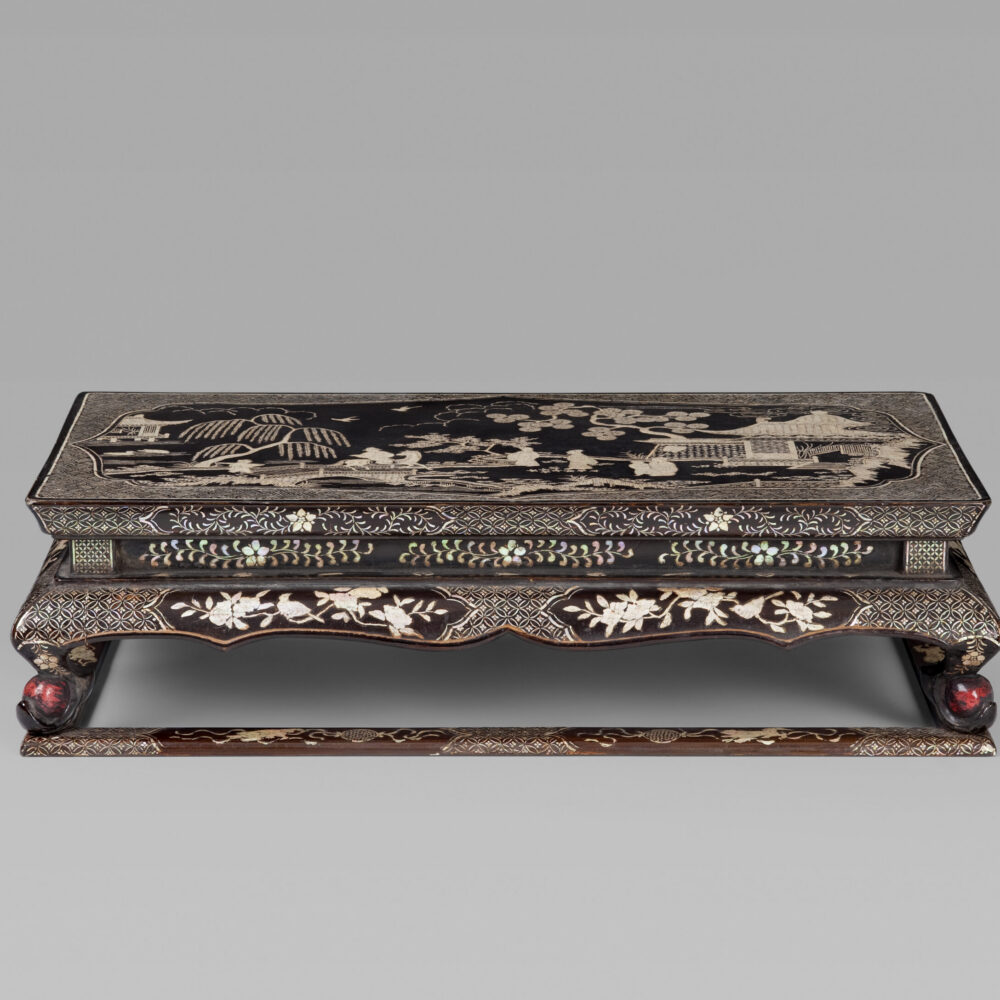 A finely carved black and red lacquer ‘Kang’ table with mother-of-pearl inlay
