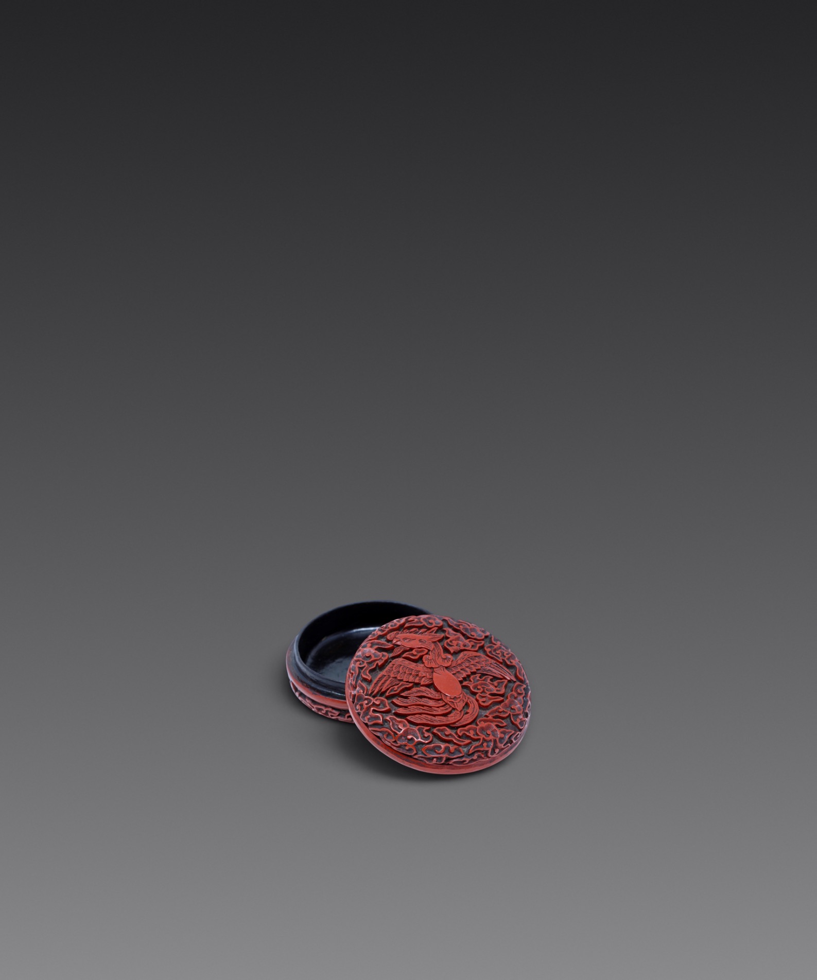 A carved cinnabar lacquer ‘phoenix’ box and cover (Yuan/Early Ming dynasty)