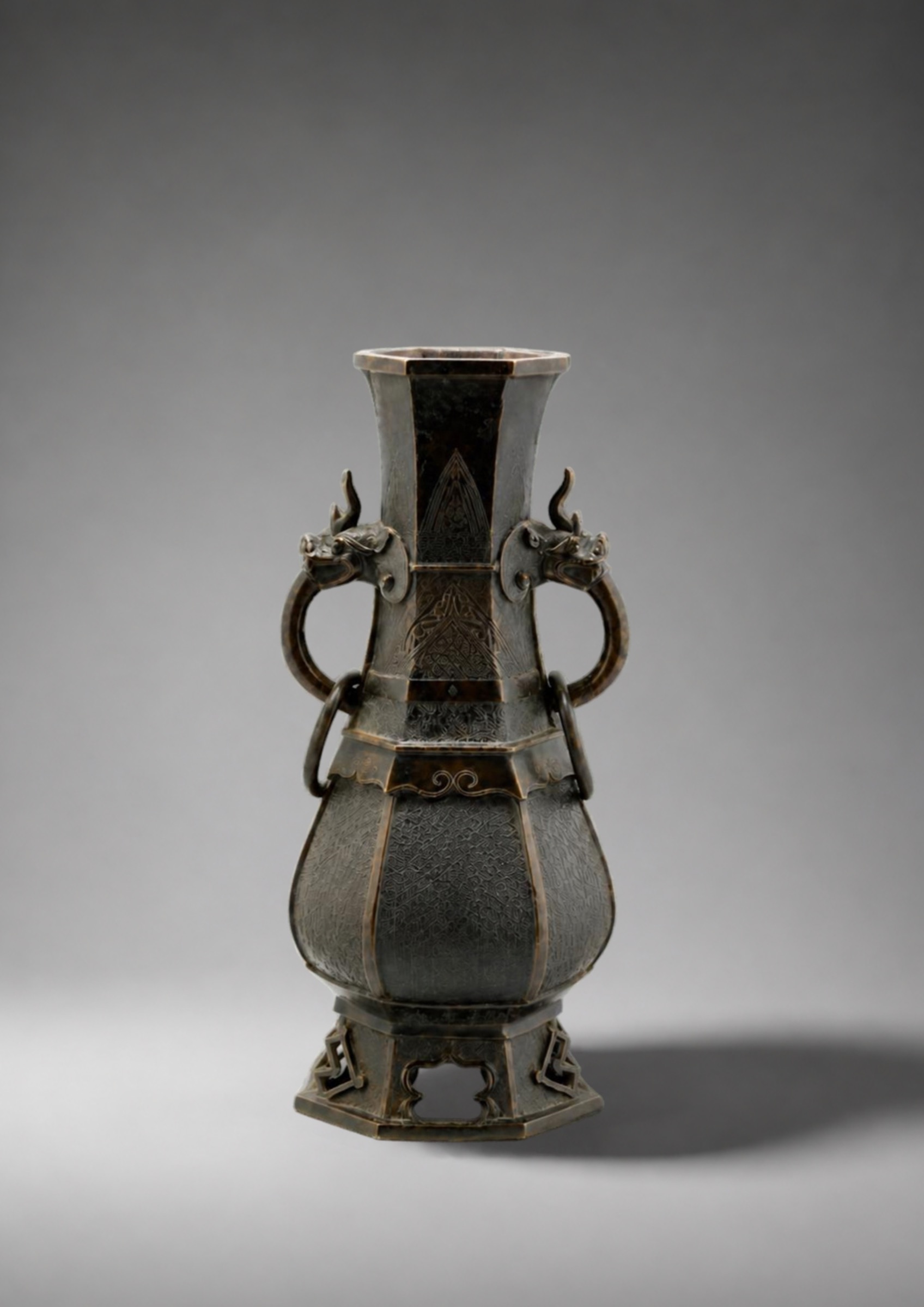 A bronze hexagonal baluster vase